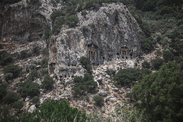Beautiful Lycian tombs in the rock. Turkish Dalyan. Remains of an ancient civilization. Ancient architecture in the rock. Beautiful mountains.