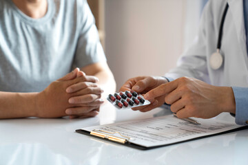 Fototapeta premium Doctor or pharmacist doctors explain and counsel patients about medications and provide medical and diagnostic information about treating the condition. in the hospital medical ethics concept