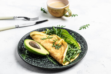Omelet and Salad with green vegetables avocado and arugula, Delicious vegan, vegetarian breakfast