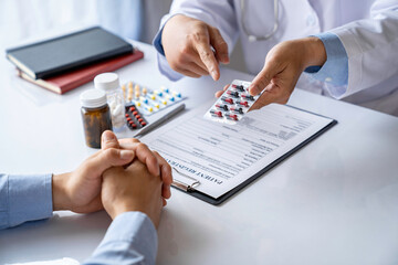 doctor or pharmacist advises patients about pills. The doctor prescribes medication sitting at a table in the clinic office. to find the best course of treatment. follow-up treatment