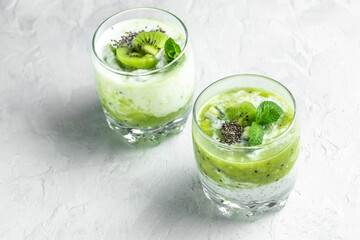 Chia pudding in a glass. Healthy breakfast. chia pudding with kiwi on light background. Long banner format. top view