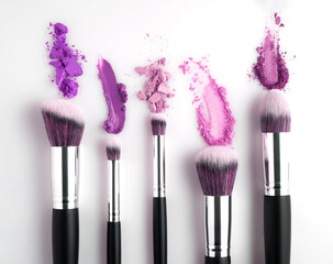 Creative concept beauty fashion photo of cosmetic product make up brushes kit with smashed lipstick eyeshadow on white background. - obrazy, fototapety, plakaty