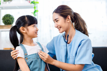 close up of happy girl and doctor on medical exam.ASian Female  doctor or nurse  Listening To Girls...