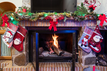 Decorated fireplace with burning fire during Christmas celebration