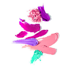 Creative beauty fashion concept photo of cosmetic products lipstick eyeshadows swatches on white background.