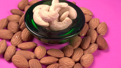 A variety mix of dried fruits and nuts on a pink background. Selective focus.Concept of Healthy fitness super food.
