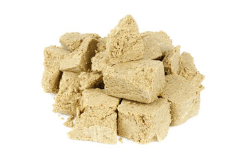 Sweet pieces of halva on a white background.