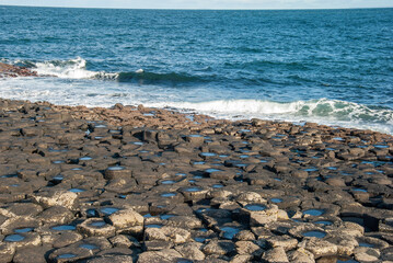 The view of the Honeycomb columns of the Giant's Causeway natural wonder and the Atlantic coast in...