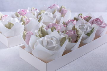 zephyr bouquet of flowers in a pink box on a light background