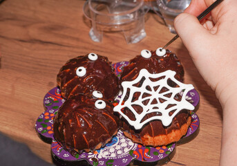 Baker decorating Halloween Cookies. Glazing cookies.
