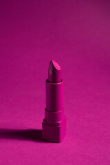 Creative concept beauty fashion photo of lipstick on pink black background.
