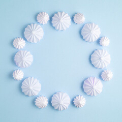 Creative concept food photo of marshmallow candies on blue background.