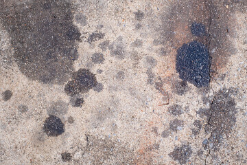 Stains of engine oil from cars that drip onto the floor in the parking lot, car engine oil, cement floor, dirt, old, top view