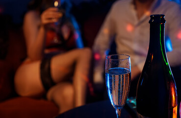 Man and stripper dancer in strip club.