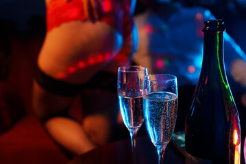 Man and stripper dancer in strip club.