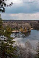 Obraz premium Spring rainy clouds on river bank recreation area. Cossack mountain (Gomilshanski forest, Koropove village) on Siverskyi Donets River in Ukraine