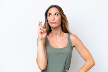 Fototapeta premium Young caucasian woman isolated on white background with fingers crossing and wishing the best