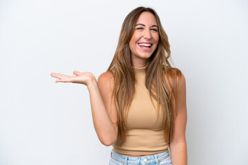 Young caucasian woman isolated on white background holding copyspace imaginary on the palm to insert an ad