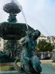 Fototapeta na wymiar Lisbon, Portugal - February, 2010: statues of mermaid at the fountain
