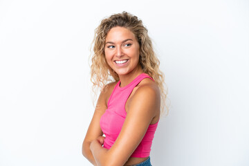 Girl with curly hair isolated on white background with arms crossed and happy