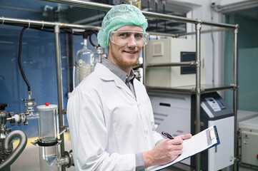 Scientists use clipboard in the machine room extracting oil and cannabis seeds	