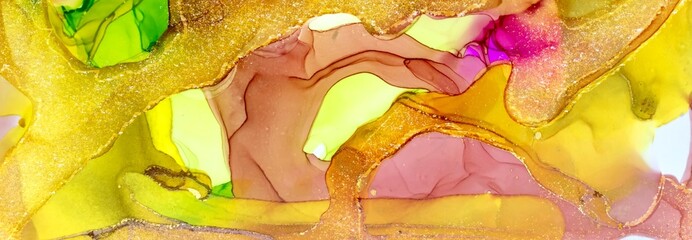 Golden dust and drops on dark yellow Alcohol ink fluid abstract texture fluid art with gold glitter and liquid.