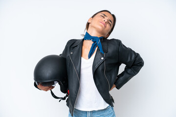 Naklejka premium Young caucasian woman with a motorcycle helmet isolated on blue background suffering from backache for having made an effort