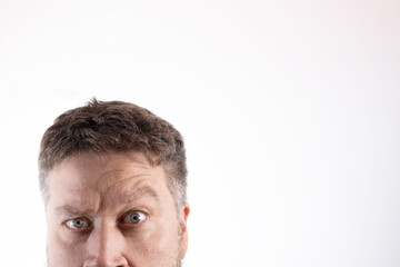 Fototapeta premium anonymous Caucasian face with blue eyes and a look of madness