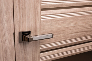 External door handle without protective lock on wooden frame.