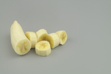 Banana slices on gray background with copy space for text.