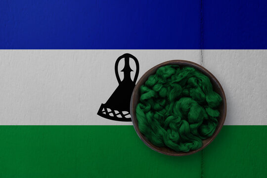 Wooden basket on background in colors of national flag. Photography and marketing digital backdrop. Lesotho