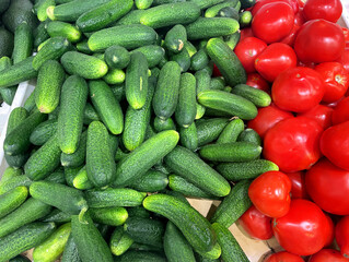 buying vegetables( tomatoes and cucumbers) at the market