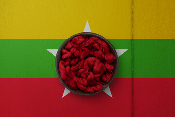 Wooden basket on background in colors of national flag. Photography and marketing digital backdrop. Myanmar