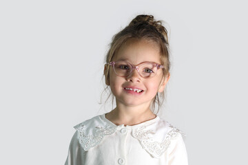 Little caucasian Girl Wearing Eye Glasses posing on white background. optician concept