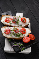 Toasts with microgreens on the table. Healthy food, vegan food and dieting concept.