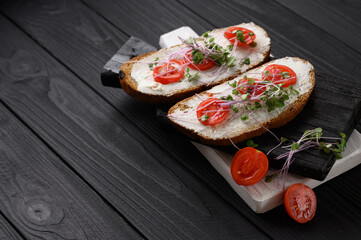 Toasts with microgreens on the table. Healthy food, vegan food and dieting concept.