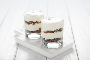 Greek yogurt with granola in glass jar. Parfait