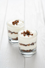 Greek yogurt with granola in glass jar. Parfait