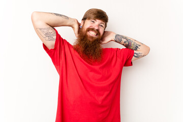 Young caucasian red-haired man isolated on white background stretching arms, relaxed position.