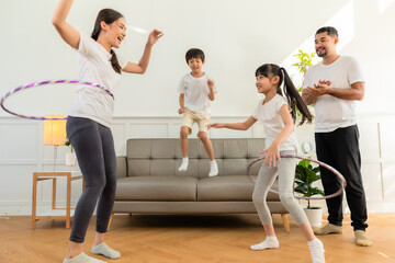 Fototapeta premium Young asian parents with child meditating at home isolated in room. Family, sport, yoga concept.