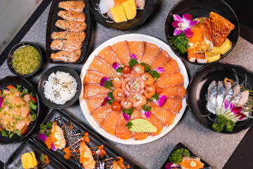 Sashimi sushi set with soy on black background.Assorted sushi set served on dark stone slate background. Top view