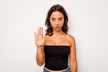 Young hispanic woman isolated on white background standing with outstretched hand showing stop...