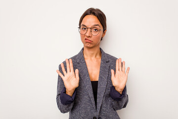 Young hispanic woman isolated on white background rejecting someone showing a gesture of disgust.