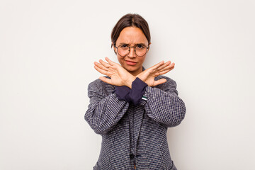 Young hispanic woman isolated on white background doing a denial gesture