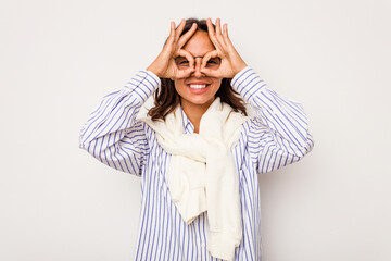 Young hispanic woman isolated on white background excited keeping ok gesture on eye.