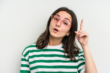 Young caucasian woman wearing a glasses isolated on blue background having an idea, inspiration concept.