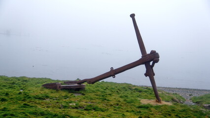 Old rusted anchor at the old whaling station in Grytviken, South Georgia Island, on a foggy morning
