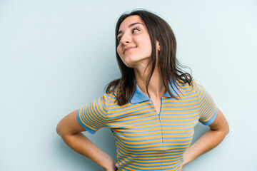 Young caucasian woman isolated on blue background confident keeping hands on hips.