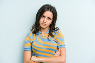 Fototapeta premium Young caucasian woman isolated on blue background who is bored, fatigued and need a relax day.