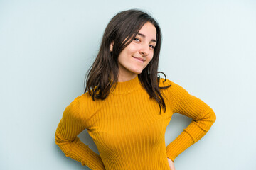 Young caucasian woman isolated on blue background happy, smiling and cheerful.